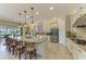 Spacious kitchen with white cabinets, granite countertops, and a large center island with seating at 13214 Treviso Dr, Bradenton, FL 34211