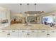 Elegant kitchen island with pendant lighting overlooking the dining and living area at 13214 Treviso Dr, Bradenton, FL 34211