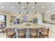 Bright kitchen featuring a large center island with seating, stainless steel appliances, and white cabinetry at 13214 Treviso Dr, Bradenton, FL 34211