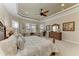 Relaxing main bedroom featuring neutral carpet, elegant decor, and a cozy sitting area with large windows at 13214 Treviso Dr, Bradenton, FL 34211