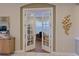 A bright office space featuring double doors, desk, chair, and attractive decor at 13214 Treviso Dr, Bradenton, FL 34211