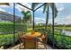 Relaxing screened-in patio with a table and chairs overlooking a scenic view at 13214 Treviso Dr, Bradenton, FL 34211