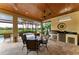 Screened patio area with an outdoor kitchen, dining set, and views of lush landscaping at 13214 Treviso Dr, Bradenton, FL 34211