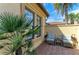 Private patio featuring palm trees, stone pavers, and comfortable seating at 13214 Treviso Dr, Bradenton, FL 34211