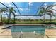 Screened-in pool with lovely lake views, fountains, and spa at 13214 Treviso Dr, Bradenton, FL 34211
