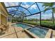 Screened pool area includes a spacious pool, hot tub, lounging area, and views of the lake at 13214 Treviso Dr, Bradenton, FL 34211