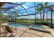 Screened-in pool with a lake view and outdoor furniture at 13214 Treviso Dr, Bradenton, FL 34211