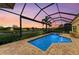 Beautiful pool and spa with a view of the lake at sunset at 13214 Treviso Dr, Bradenton, FL 34211