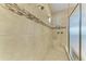 Walk-in shower with dual shower heads, mosaic tile detailing, and a built-in bench for convenience at 13214 Treviso Dr, Bradenton, FL 34211