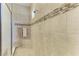 Modern shower with decorative tile accents, built-in bench, and glass enclosure for a spa-like experience at 13214 Treviso Dr, Bradenton, FL 34211