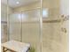 Contemporary shower featuring sleek glass doors, tile accents, and a comfortable seating area at 13214 Treviso Dr, Bradenton, FL 34211