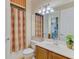 Bright bathroom with decorative shower curtain and vanity at 1345 Burgos Dr # 101, Sarasota, FL 34238