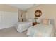 Comfortable bedroom includes twin beds, closet, and decorative mirror at 1345 Burgos Dr # 101, Sarasota, FL 34238