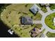 An overhead view shows a meticulously landscaped home with a private pool and a boat dock at 14540 Gaspar Loop, Port Charlotte, FL 33981