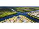 Stunning aerial view of a waterfront home nestled between a river and canal, surrounded by lush greenery at 14540 Gaspar Loop, Port Charlotte, FL 33981
