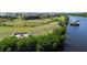 Beautiful waterfront property featuring a private dock, fire pit, and lush landscaping at 14540 Gaspar Loop, Port Charlotte, FL 33981