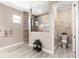 Modern bathroom featuring a glass enclosed shower with decorative wood look tile, and a separate toilet room at 14540 Gaspar Loop, Port Charlotte, FL 33981