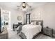 Stylized bedroom with contemporary decor, a desk, ceiling fan, and a comfortable bed at 14540 Gaspar Loop, Port Charlotte, FL 33981