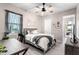 Comfortable bedroom with a desk, ceiling fan, a cozy bed, and a view into the backyard at 14540 Gaspar Loop, Port Charlotte, FL 33981