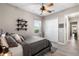 Bedroom showcasing a comfortable bed, a ceiling fan, a closet, and a view into the hallway at 14540 Gaspar Loop, Port Charlotte, FL 33981