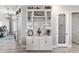 A Butler Pantry complete with wine storage, marble backsplash, and a decorative pantry door at 14540 Gaspar Loop, Port Charlotte, FL 33981
