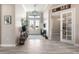 Spacious entryway with double doors, transom window, stylish console table, and seamless access to adjacent rooms at 14540 Gaspar Loop, Port Charlotte, FL 33981