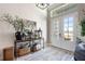 Welcoming entryway features a stylish console table, decorative mirror, and double doors with transom windows at 14540 Gaspar Loop, Port Charlotte, FL 33981
