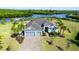 A beautiful waterfront home with a three-car garage and lush tropical landscaping at 14540 Gaspar Loop, Port Charlotte, FL 33981