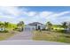 Beautiful house with a three-car garage, nice landscaping, and a paver driveway at 14540 Gaspar Loop, Port Charlotte, FL 33981