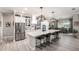 Open concept kitchen with a large island, stainless steel appliances, and views into the dining area at 14540 Gaspar Loop, Port Charlotte, FL 33981