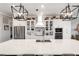 Modern kitchen featuring a large island, stainless steel appliances, and custom cabinetry with glass doors at 14540 Gaspar Loop, Port Charlotte, FL 33981