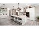 Bright, modern kitchen with a large center island, pendant lighting, and stainless-steel appliances at 14540 Gaspar Loop, Port Charlotte, FL 33981