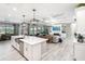Open-concept living space with a kitchen island, coffered ceilings, and seamless flow at 14540 Gaspar Loop, Port Charlotte, FL 33981
