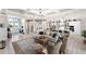 Bright, open-concept living room with coffered ceilings, chandelier, and seamless flow to kitchen at 14540 Gaspar Loop, Port Charlotte, FL 33981