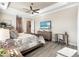 Comfortable main bedroom featuring wood-look tile floors, a ceiling fan, and neutral decor at 14540 Gaspar Loop, Port Charlotte, FL 33981