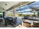 Outdoor patio featuring a covered bar and cooking area, comfortable seating and views of the pool at 14540 Gaspar Loop, Port Charlotte, FL 33981