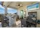 Covered patio featuring a fully equipped outdoor kitchen with a bar and a dining table at 14540 Gaspar Loop, Port Charlotte, FL 33981