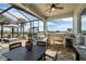 Outdoor kitchen area with a grill, bar seating, and views of the palm trees and lounge chairs at 14540 Gaspar Loop, Port Charlotte, FL 33981