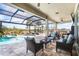 Inviting outdoor patio with comfortable seating, a view of the pool, and an outdoor kitchen at 14540 Gaspar Loop, Port Charlotte, FL 33981