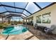 Beautiful pool and patio area in a screened in lanai, perfect for entertaining and enjoying the outdoors at 14540 Gaspar Loop, Port Charlotte, FL 33981