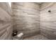 Close up of wood-look tile shower with built-in bench, tiled floor and decorative shower head at 14540 Gaspar Loop, Port Charlotte, FL 33981