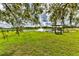 Lush green lawn leads to pond with fountain, dock and wooden gazebo at 15890 County Road 675, Parrish, FL 34219