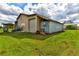 Exterior shot of a metal barn with open shelters and a storage container at 15890 County Road 675, Parrish, FL 34219