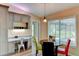 Dining area features a built in desk, table with modern light fixture and a large window at 15890 County Road 675, Parrish, FL 34219