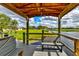 Inviting waterfront dock area, featuring a comfortable bench overlooking a tranquil pond, and scenic views at 15890 County Road 675, Parrish, FL 34219