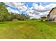 Expansive green lawn, metal barn, and shooting range target at 15890 County Road 675, Parrish, FL 34219
