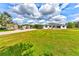 Beautiful home with well-kept lawns, complemented by multiple garages that provide ample storage and parking space at 15890 County Road 675, Parrish, FL 34219