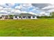 Charming single-story home features a well-manicured lawn and freshly painted white exterior at 15890 County Road 675, Parrish, FL 34219