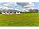 Well-maintained home features a lush green lawn, freshly painted white exterior, and black shutters at 15890 County Road 675, Parrish, FL 34219
