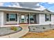 Charming front porch with rocking chairs, decorative shrubbery and well-maintained landscaping at 15890 County Road 675, Parrish, FL 34219